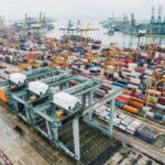 Freight containers moving through a modern logistics hub