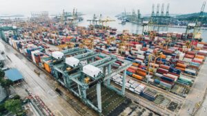 Freight containers moving through a modern logistics hub
