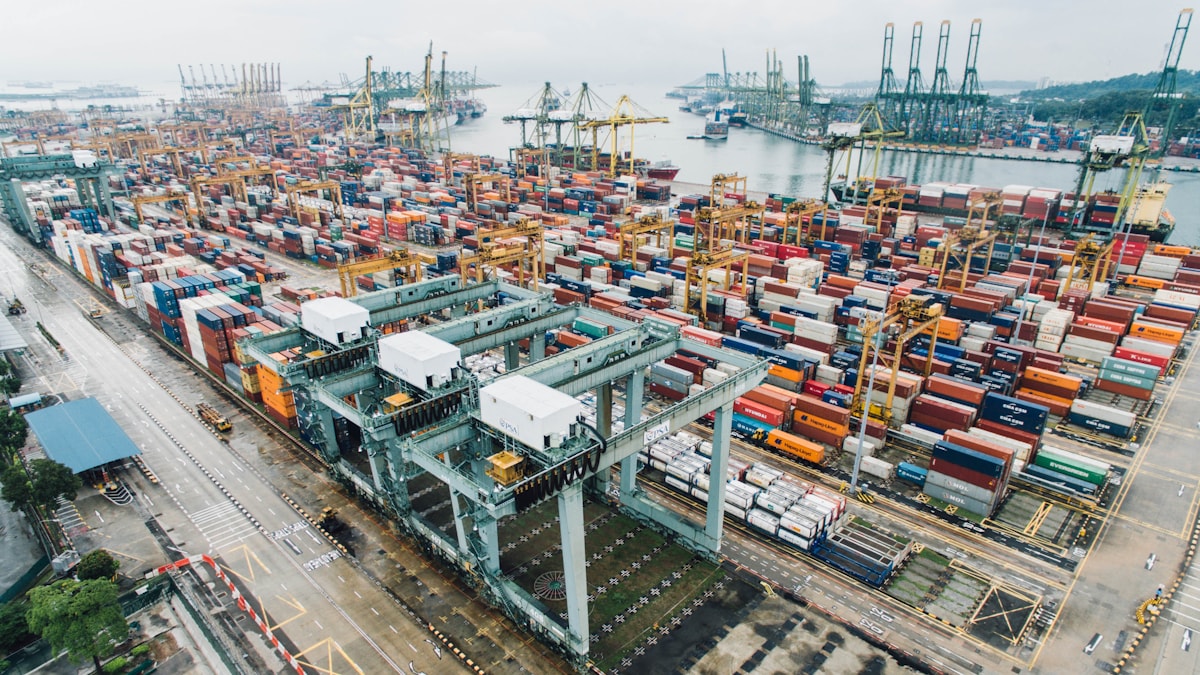 Freight containers moving through a modern logistics hub